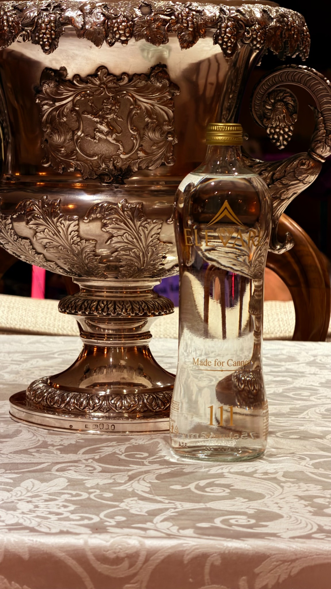 ELEVARE111 bottle beside a silver piece in the Callas Lounge aboard Christina O