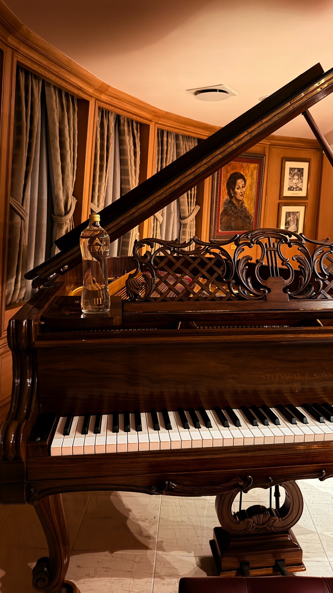ELEVARE111 bottle resting on a Steinway grand piano in the Callas Lounge